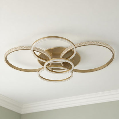 Moderne plafondlamp LORELEI met champagnekleurige ringen – sfeerbeeld